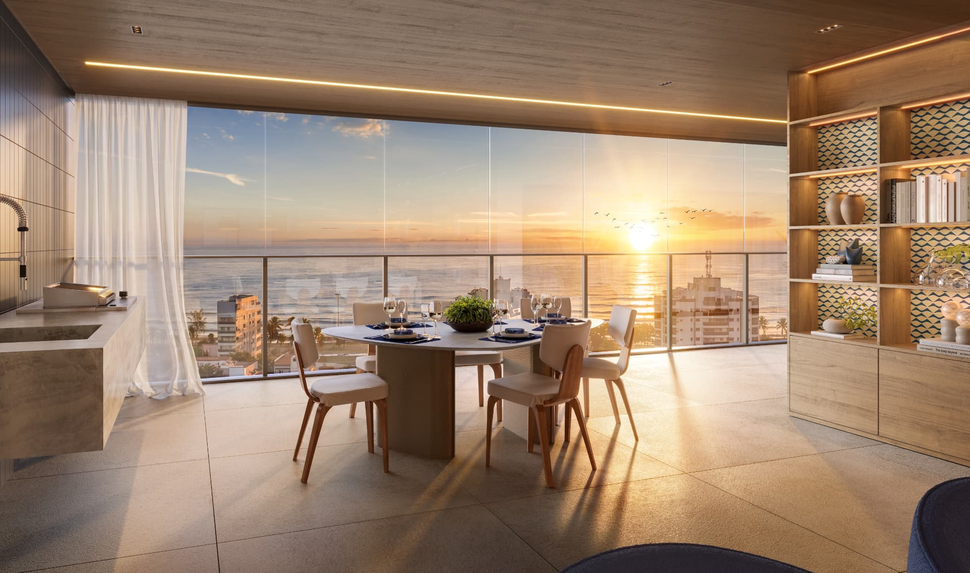 Sala do Marino by Breton integrada à varanda com vista para o mar no Posto 6 da Barra da Tijuca ao pôr do sol